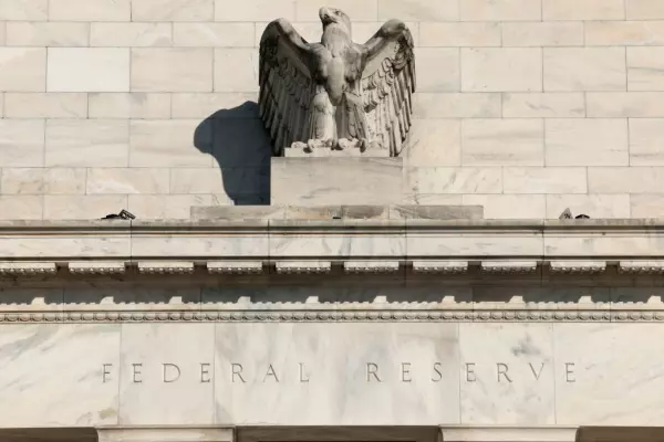 Fed holds rates steady but keeps door open to another hike