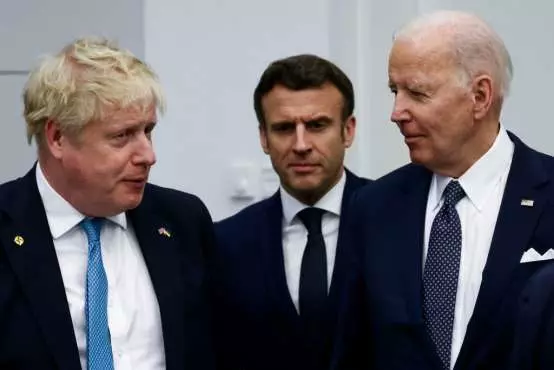 British PM Boris Johnson, France's President Emmanuel Macron and US President Joe Biden during a NATO summit on Russia's invasion of Ukraine. (Image: Getty)