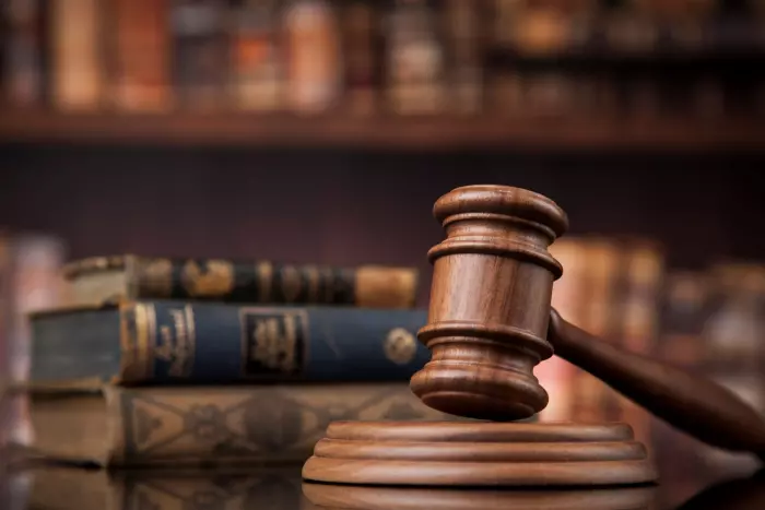 Senior lawyer suspended for grabbing colleague’s genitals, making lewd comments