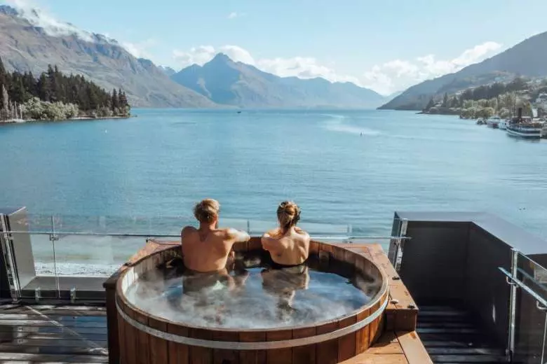 Admiring the view of Lake Wakatipu from The Penthouse hot tub. (Photo: Supplied)